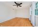 Bedroom features hardwood floors, a ceiling fan, and a window with a view of the outdoors at 6146 Rucker Rd, Indianapolis, IN 46220