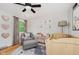Cozy Bedroom with accent wall decor, comfortable armchair, wooden crib, and decorative ceiling fan at 6146 Rucker Rd, Indianapolis, IN 46220