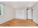 Bedroom with hardwood floors, a closet with sliding doors, and a white door entering to another room at 6146 Rucker Rd, Indianapolis, IN 46220