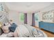 Comfortable bedroom featuring modern decor, hardwood floors and natural light at 6146 Rucker Rd, Indianapolis, IN 46220
