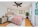 Bedroom featuring neutral paint, hardwood flooring, ceiling fan and light-filled windows at 6146 Rucker Rd, Indianapolis, IN 46220