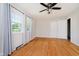Bedroom with hardwood floors, a ceiling fan, closet, and a window with a view of the outdoors at 6146 Rucker Rd, Indianapolis, IN 46220