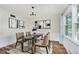 Elegant dining area with a marble-top table, stylish chairs, and modern art at 6146 Rucker Rd, Indianapolis, IN 46220