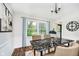 Bright dining room features stylish black marble table set next to a large window at 6146 Rucker Rd, Indianapolis, IN 46220