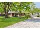 Inviting two-story home with a well-maintained lawn and a gravel driveway at 6146 Rucker Rd, Indianapolis, IN 46220