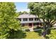Beautiful front exterior with lush landscaping, a well-maintained lawn, and mature trees at 6146 Rucker Rd, Indianapolis, IN 46220