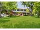 Charming two-story home featuring a manicured lawn and mature trees at 6146 Rucker Rd, Indianapolis, IN 46220