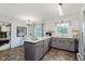 This kitchen features gray cabinets, white upper cabinets and counter, and newer appliances at 6146 Rucker Rd, Indianapolis, IN 46220
