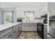 Well-lit kitchen featuring neutral-toned cabinets and modern appliances at 6146 Rucker Rd, Indianapolis, IN 46220