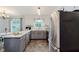 Kitchen features stainless steel appliances, gray and white cabinets, and dining area at 6146 Rucker Rd, Indianapolis, IN 46220