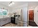 Kitchen offers gray cabinets, white upper cabinets, stainless steel appliances, and tile floor at 6146 Rucker Rd, Indianapolis, IN 46220