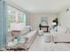 Bright living room features neutral tones, comfortable seating, and large windows at 6146 Rucker Rd, Indianapolis, IN 46220