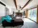 Living room showcases exposed beams, brick fireplace, and sliding glass doors to outside at 6146 Rucker Rd, Indianapolis, IN 46220