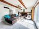 The living room features wooden beams, fireplace, brown sofa, and natural light at 6146 Rucker Rd, Indianapolis, IN 46220