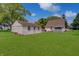 Large backyard featuring a storage shed and the exterior of the house at 616 S Fuller Dr, Indianapolis, IN 46241