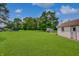 Manicured lawn with shed and partial view of the home at 616 S Fuller Dr, Indianapolis, IN 46241