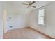 A bedroom featuring neutral walls, ceiling fan, and a window at 616 S Fuller Dr, Indianapolis, IN 46241