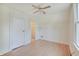A bedroom featuring neutral walls, ceiling fan, a closet, and two shelves at 616 S Fuller Dr, Indianapolis, IN 46241