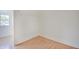 Bedroom featuring hardwood floors, white walls, and an electrical outlet at 616 S Fuller Dr, Indianapolis, IN 46241
