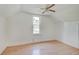 Upstairs room with a window and ceiling fan at 616 S Fuller Dr, Indianapolis, IN 46241