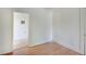 Bedroom with hardwood floors, white walls, and an entry leading to another room at 616 S Fuller Dr, Indianapolis, IN 46241