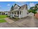 Charming two-story home with a welcoming front porch, landscaped garden, and detached garage at 616 S Fuller Dr, Indianapolis, IN 46241