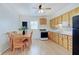 Eat-in kitchen featuring wood cabinets, an oven, and a dining table with six chairs at 616 S Fuller Dr, Indianapolis, IN 46241