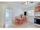 Bright eat-in kitchen with table and chairs, ceiling fan, chalkboard and white appliances at 616 S Fuller Dr, Indianapolis, IN 46241