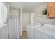 Bright laundry room featuring a washer and dryer along with a shower stall with curtain at 616 S Fuller Dr, Indianapolis, IN 46241