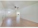Open-concept living room with laminate wood floors, white trim, and staircase at 616 S Fuller Dr, Indianapolis, IN 46241