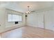 Bright room featuring large window, built in storage and shelving and laminate wood flooring at 616 S Fuller Dr, Indianapolis, IN 46241