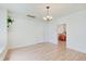 Spacious living room with laminate wood flooring, bright light, and dining room view at 616 S Fuller Dr, Indianapolis, IN 46241