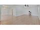 Bright living room featuring laminate wood flooring and modern ceiling fan at 616 S Fuller Dr, Indianapolis, IN 46241