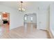 Bright living room featuring archways, laminate wood flooring, chandelier, and white trim at 616 S Fuller Dr, Indianapolis, IN 46241