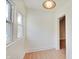 A bright, vacant room with hardwood flooring and an open door at 616 S Fuller Dr, Indianapolis, IN 46241