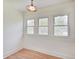 Bright room featuring multiple windows and hardwood flooring at 616 S Fuller Dr, Indianapolis, IN 46241