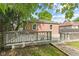 A backyard with a brick house and a wooden deck, under a partly cloudy sky at 6477 N Park Ave, Indianapolis, IN 46220