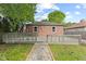 Backyard of brick home features wood deck, walkway, and green lawn area at 6477 N Park Ave, Indianapolis, IN 46220