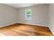 Empty bedroom with hardwood floors and a bright window at 6477 N Park Ave, Indianapolis, IN 46220