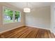 Elegant dining room with lustrous hardwood floors and classic chandelier lighting at 6477 N Park Ave, Indianapolis, IN 46220