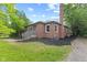 Charming red brick home featuring a well-manicured lawn and a classic chimney at 6477 N Park Ave, Indianapolis, IN 46220
