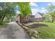 Cozy red brick home with a long driveway, a detached garage, and a well-kept lawn at 6477 N Park Ave, Indianapolis, IN 46220