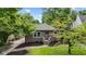 Charming single-story red brick home with a well-maintained lawn and mature trees at 6477 N Park Ave, Indianapolis, IN 46220