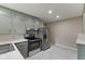 Spacious kitchen equipped with stainless steel appliances, gray cabinets, and marble floors at 6477 N Park Ave, Indianapolis, IN 46220