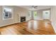 Inviting living room featuring hardwood floors, a fireplace, and plenty of natural light at 6477 N Park Ave, Indianapolis, IN 46220
