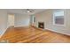 Inviting living room featuring hardwood floors, a stylish ceiling fan, and a classic fireplace at 6477 N Park Ave, Indianapolis, IN 46220