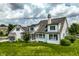 Beautiful backyard featuring a well-maintained lawn, screened-in porch, and a classic white exterior at 6685 Chapel Xing, Zionsville, IN 46077