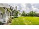 Beautiful backyard featuring a spacious lawn, mature trees, and a screened porch for outdoor enjoyment at 6685 Chapel Xing, Zionsville, IN 46077