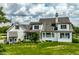 Beautiful backyard featuring a well-maintained lawn, screened-in porch, and a classic white exterior at 6685 Chapel Xing, Zionsville, IN 46077