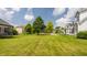 Expansive backyard with lush green lawn, mature trees, and ample space for recreation and relaxation at 6685 Chapel Xing, Zionsville, IN 46077